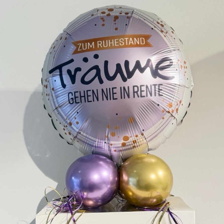 Personalisierte Ballonbox zum Ruhestand mit lila und goldenen Ballons und Folienballon „Träume gehen nie in Rente“