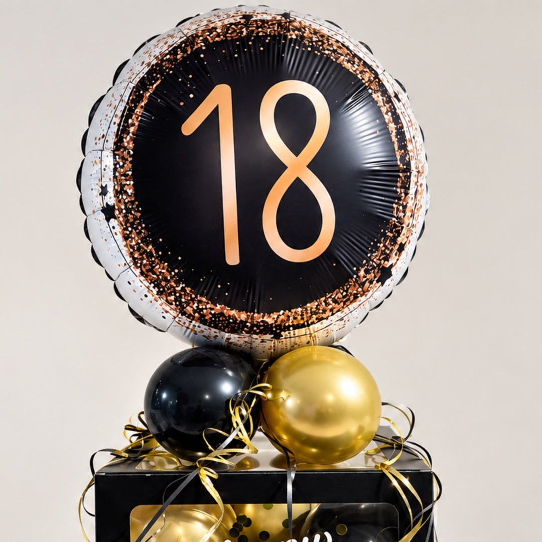 Ballonbox zum 18. Geburtstag als personalisiertes Geldgeschenk mit schwarzen und goldenen Ballons